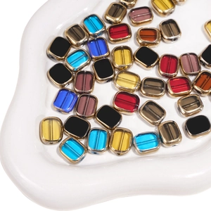 Macro detail of 10x12mm glass beads with gold metal edges for DIY jewelry making