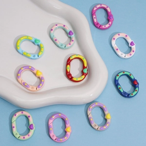 Close-up of colorful heart-shaped spring rings with polka dot pattern for DIY keychains