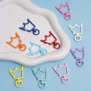 Macro detail of colorful crown shaped alloy lobster clasps with rotating connectors for DIY