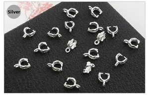 Detailed view of silver metal pendant bails with retro leaf texture for DIY jewelry making