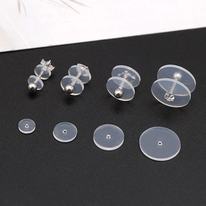 Macro shot of transparent silicone earring discs in four sizes for stable jewelry support