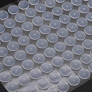 Macro detail of transparent silicone earring pads neatly arranged on a clear liner