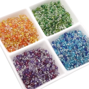 Detail view of 4mm colorful glass seed beads in green, yellow, blue and purple for DIY jewelry