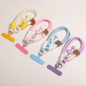 Detail showing colorful braided lanyards with stars, clouds, and charms for phone DIY