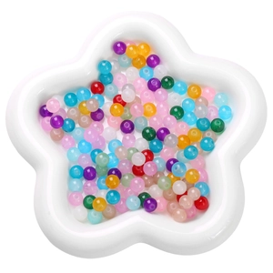 Colorful round glass beads in star container for DIY jewelry and necklaces