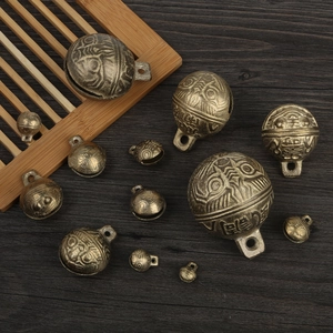 Detailed macro view of vintage bronze tiger head bells with traditional embossed patterns