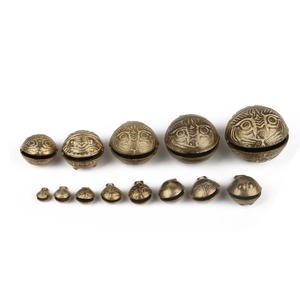 Vintage brass tiger head bells in multiple sizes for DIY jewelry crafts on white background