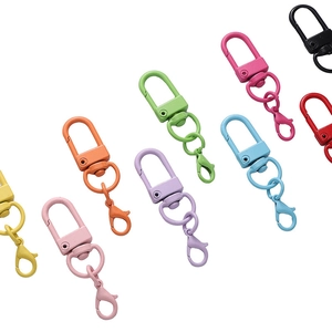 Macro view of assorted colorful lobster clasps and swivel rings for DIY keychain crafts