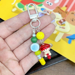 Gros plan d'un porte-clés de perles DIY avec un joli pendentif de poupée champignon