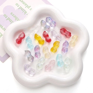 Detailed macro shot of 12x23mm multi-colored glass peanut beads in a decorative tray