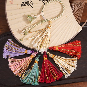 Macro view of colorful handmade cotton tassels with woven loops for DIY jewelry crafts