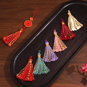Close-up of handmade Tibetan cotton tassels in various colors for DIY craft jewelry