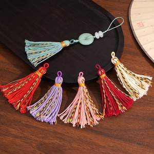 Detailed view of handmade colorful cotton tassels with jade-like ring for DIY craft jewelry