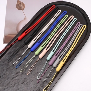 Detailed view of ten colorful liquid silicone lanyards for phones and keys in a black tray