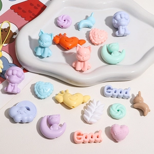Macro shot of colorful acrylic animal and heart beads for DIY jewelry making