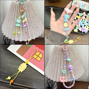Macro shot of colorful acrylic cartoon charms for DIY jewelry and phone straps