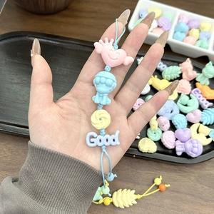 Detail of macaron acrylic beads keychain featuring heart charm and lettered disc