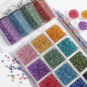 Macro shot of colorful faceted glass seed beads in transparent DIY storage containers
