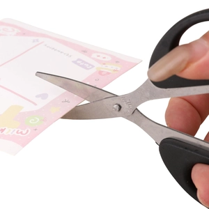 Multipurpose stainless steel office scissors with black handle cutting pink paper