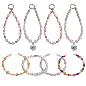 Assorted DIY jewelry beads and charms featuring crystals, pearls and butterfly pendants