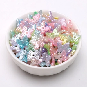 Macro shot of 10x11mm pastel macaron butterfly pearls in a ceramic bowl for DIY jewelry