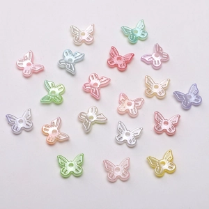 Macro shot of 10x11mm pearlized butterfly beads in various macaron colors for DIY jewelry