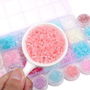 Macro shot of pink cat eye glass beads in a spoon for DIY jewelry making sets