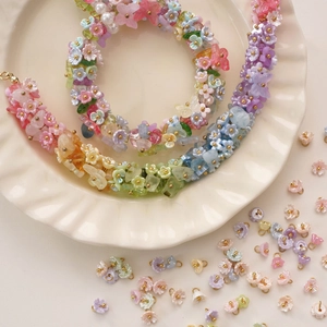 Detailed macro view of colorful resin lily of the valley flower beads and jewelry charms