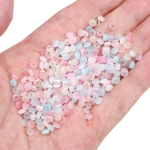 Mix of colorful 4x2.5mm glass cat eye beads for DIY jewelry making displayed on hand