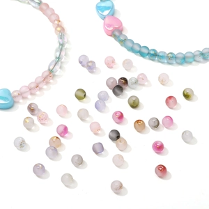 Macro detail of 4mm frosted glass beads with gold foil for DIY jewelry making and crafts