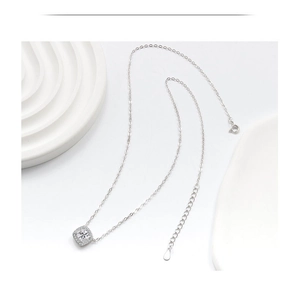 Close-up of minimalist square zircon pendant necklace on elegant white display stand