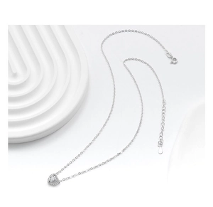 Detailed close-up of a silver heart necklace with micro-pave cubic zirconia on white background