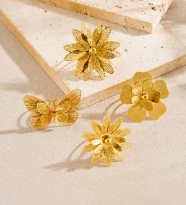 Detailed view of gold plated stainless steel rings featuring hollow flowers and butterfly