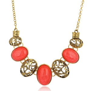 Vintage gold hollow oval necklace with red stones and ethnic style details