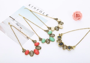 Detailed macro view of vintage hollow oval necklaces with colorful resin stones