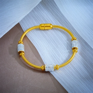 Detail of 18k gold plated magnetic clasp and sparkling crystals on a snake chain bracelet