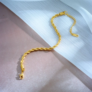 Detailed close-up of gold stainless steel snake chain with lobster clasp and tag