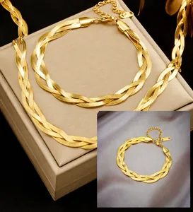 Macro detail of gold three-strand braided snake chain bracelet with lobster clasp