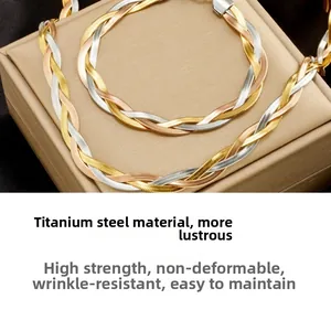 Close-up of tricolor braided titanium steel necklace and bracelet set with snake chain detail