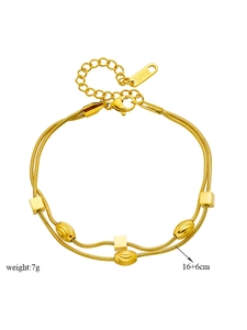 Detail of gold double snake chain bracelet with geometric beads and S.Steel tag