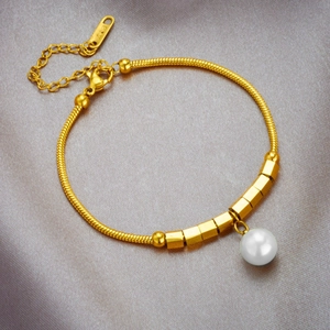 Elegant gold snake chain bracelet with white pearl pendant and golden beads on silk