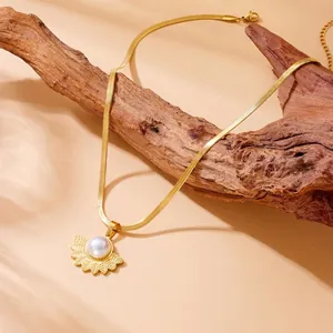 Vintage golden fan-shaped necklace with pearl pendant on a sleek snake bone chain