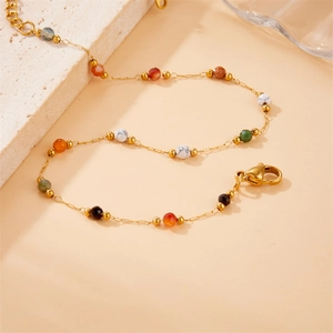 Detailed shot of multi-color stone beaded gold chain bracelet with lobster clasp