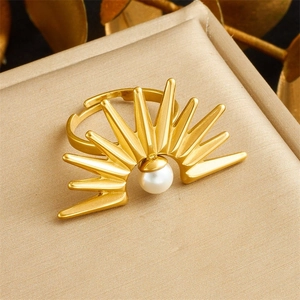 Macro detail of sunburst gold ring with central white pearl and adjustable band