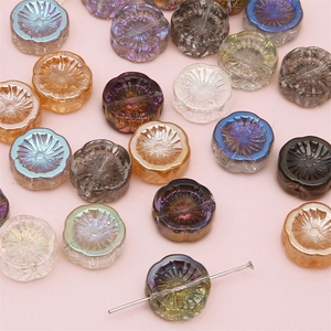 Colorful aurora glass flower beads for DIY jewelry making displayed with pin detail