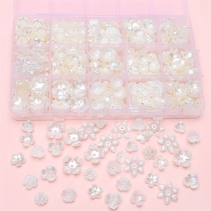 Macro shot of assorted white pearlescent flower beads for DIY jewelry with organizer box