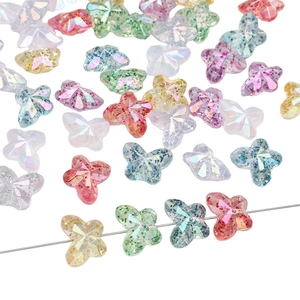 Macro shot of colorful acrylic butterfly beads with glitter finish and pre-drilled holes