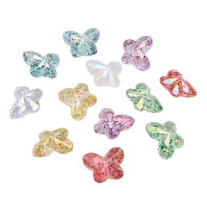 Macro detail of colorful butterfly acrylic beads with sparkling glitter for DIY jewelry