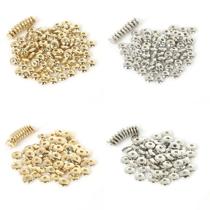 Detailed macro view of gold and silver saucer spacer beads for DIY jewelry making