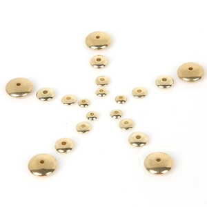 Close-up of golden flat disk spacer beads in various sizes for DIY jewelry making